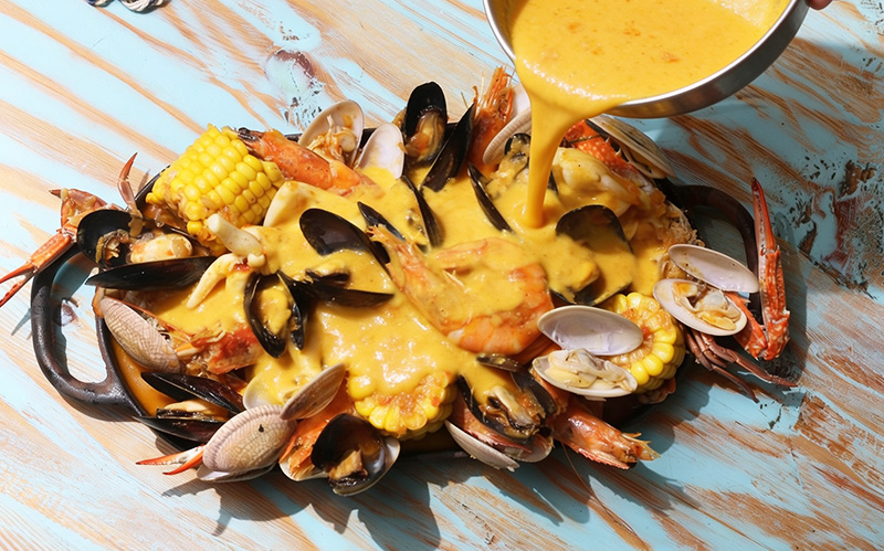 creamy-salted-egg-sauce-poured-over-fresh-mixed-seafood